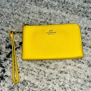 yellow coach handbag that is in pretty good quality.